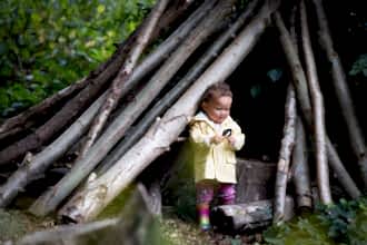 Child at Walthamstow Wetlands in a den