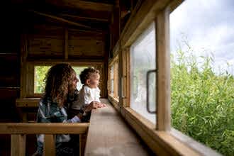 Woman and child in the bird hide at Walthamstow Wetlands