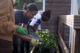 A group of young people planting a wildlife garden at Centre for Wildlife Gardening.