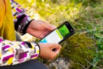 Someone using their phone to record a plant