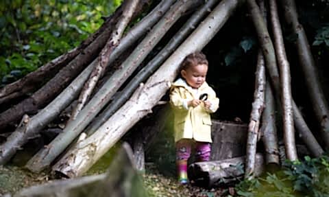 Child at Walthamstow Wetlands in a den