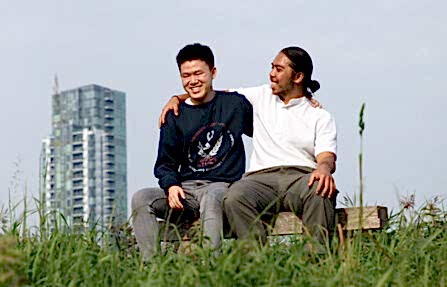 Two young people sitting on bench at Woodberry Wetlands 